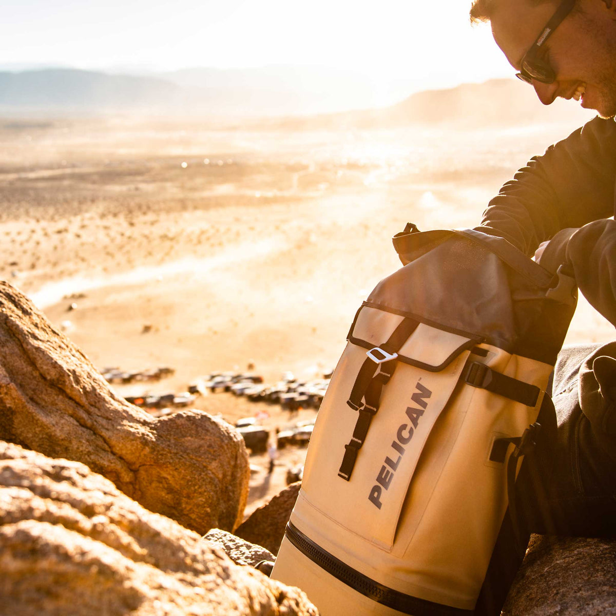 SOFT-CBKPK-COYOTE Pelican™ Dayventure Backpack Soft Cooler being used in the desert